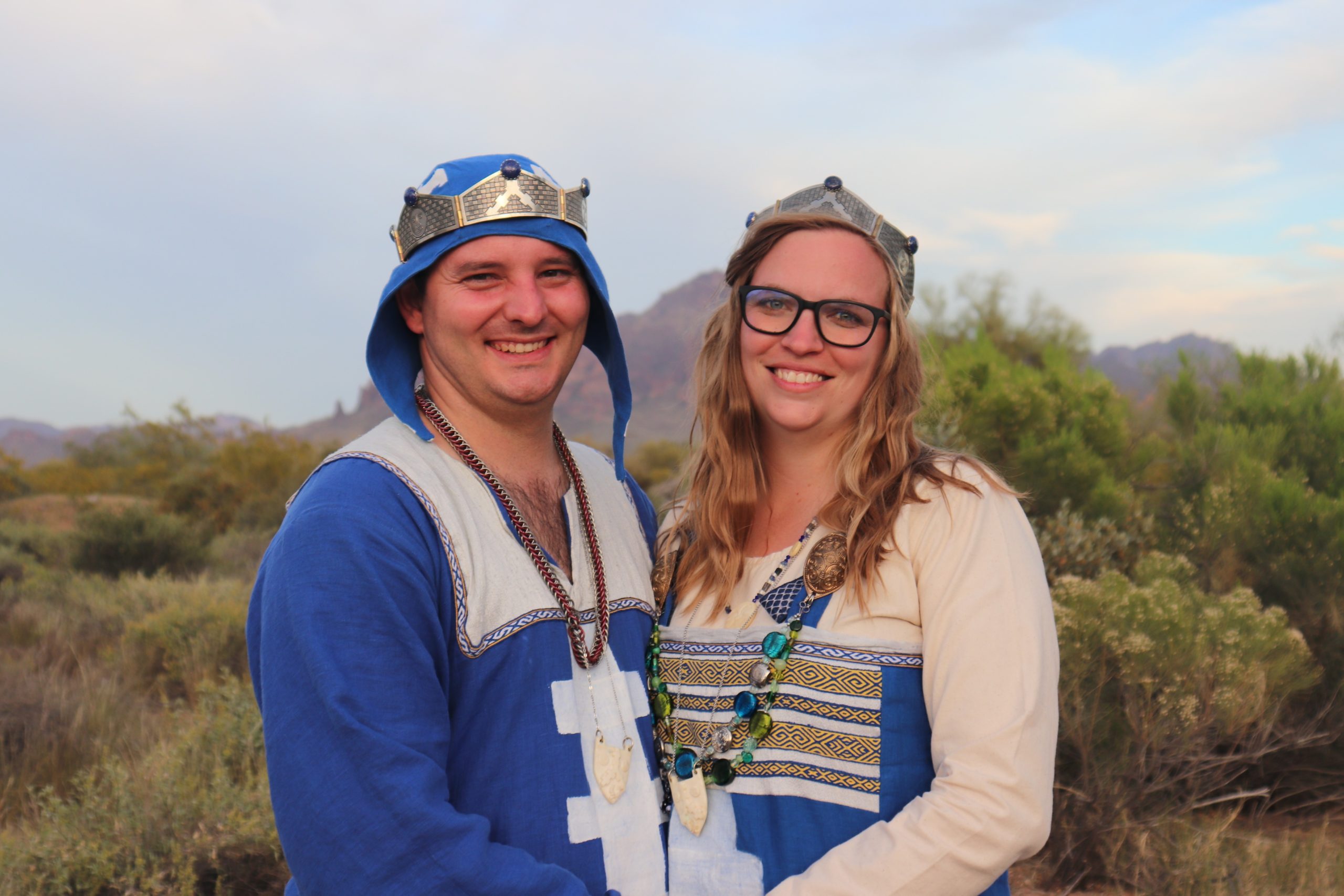 the sitting baron and baroness standing in front of a desert and mountain background